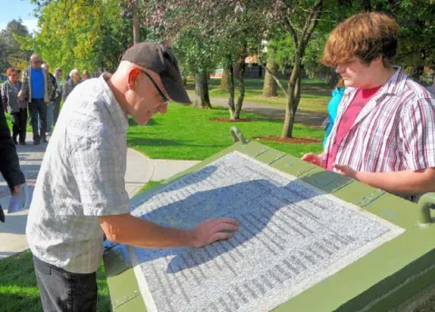 Spectators view list of those who died on duty or as a result of their service at CFB Chilliwack
