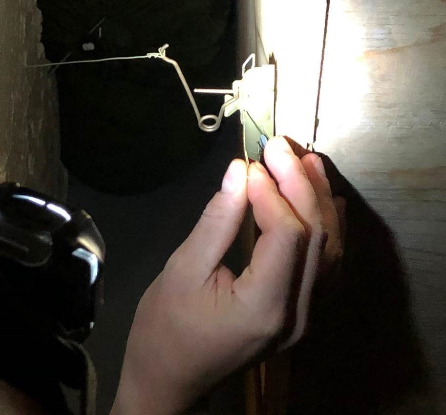 A member of 61 Fd Tp places a pin in an FIAI device to neutralize it