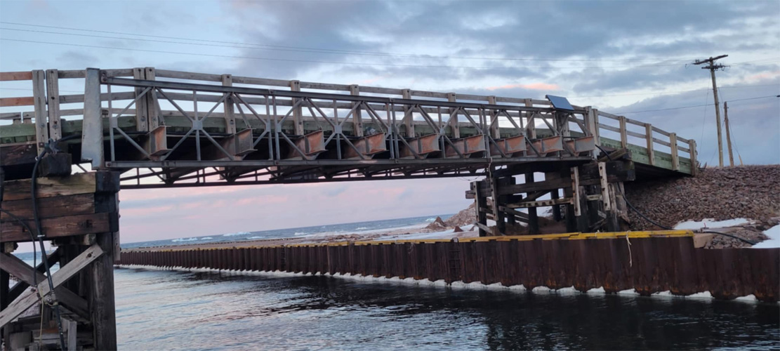 The Bailey Bridge at Naufrage Harbour, Prince Edward Island, crosses the Naufrage River as it goes out to sea. It is accessible via Harbour Road.