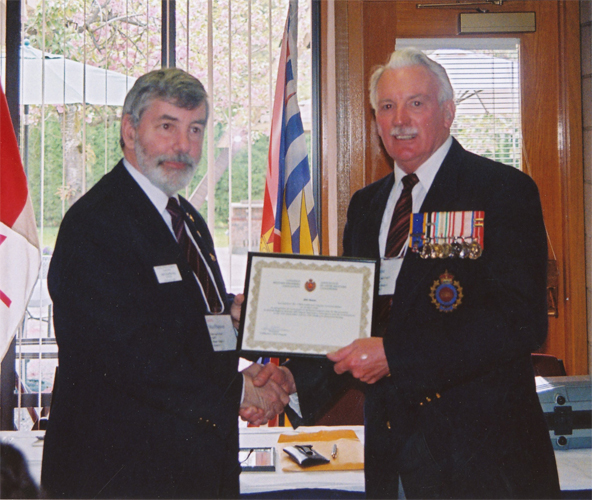 Capt Bill STone, CD (Ret'd) receiving the CMEA Commendation from President John MacPherson