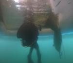 Member of 2 CER Dive team bringing down a body bag through ice // Un membre de l’équipe de plongée du 2 RGC emportant un sac mortuaire à travers la glace