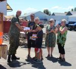 Maj Fenton handing Comox chapter contributions to Marc, Kaitha and their family