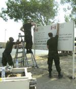 Removing Camp MIRAGE sign