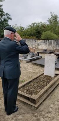 BGen Irwin saluting the grave of Pvt Herbert in Lesperon