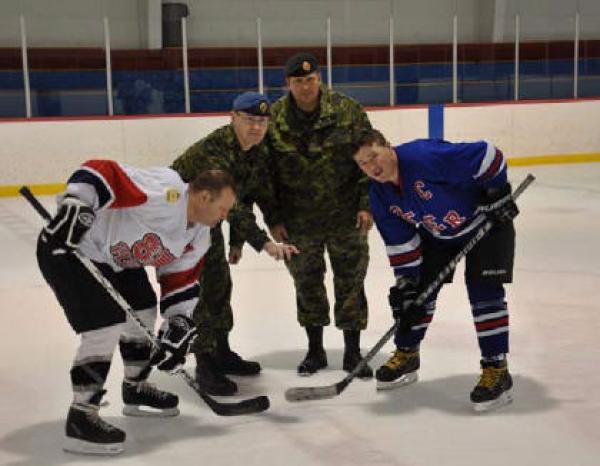 The ceremonial puck drop from left to right is MWO Marc Pacaud, Major Renald Nelson WCEO, MWO Daryl Foster and MCpl Frank McCafferty