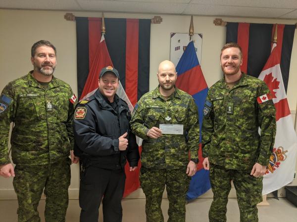 MCpl Richard accepting bursary cheque on behalf of Amy Bouchard (CWO Rondeau, Nicholas Bazinet-Deschamps, MCpl Richard and LCol Patry)