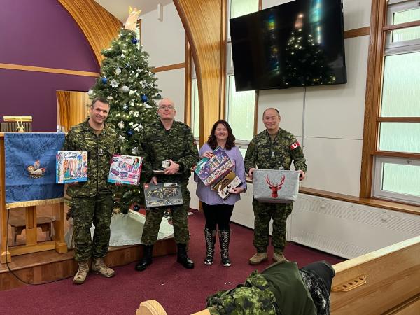 A Heartwarming Community Effort – (L-R) RPOU(W) CO, LCol John Hallett, RPOU(W) RSM, CWO Eric Barney, RPOU(W) Assistant Administrative Officer, Angela Richard, and RPOU(W) Operations Officer, Capt Kyle Ho at the base Church, CFB Edmonton.  Photo by: Michelle Cure, Chapel Admin