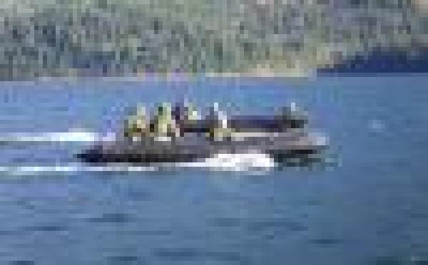 An assault boat from 39 Combat Engineer Regiment parallels the vehicle raft during a crossing of Cultus Lake during Exercise Worthy Sapper on 21 Feb 2015. 