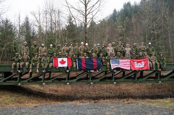 3rd Cdn Div Sappers with comrades from the 671st Multi-Role Bridging Company. atop a completed MGB