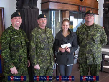 Ashley McPherson,the daughter of MWO J.W. McPherson (Edmonton), receiving the bursary cheque from WO C. Kavanagh, MWO J. McPherson and MWO M. Dumont.