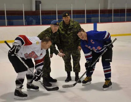 The ceremonial puck drop from left to right is MWO Marc Pacaud, Major Renald Nelson WCEO, MWO Daryl Foster and MCpl Frank McCafferty