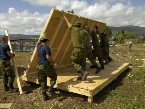 This 2010 photo shows members of the 74 Construction Troop from 4 Engineering Support Regiment building a structure for an orphanage in Haiti. DND photo. 