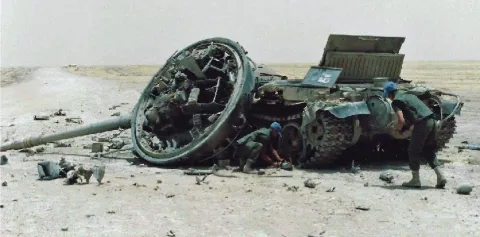 Sappers examine Iraqi tank in Kuwait