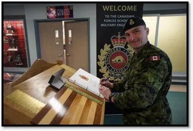 ADM(IE)’s Chief of Staff, MGen Sylvain Sirois, signs the guest book while attending Exercise UBIQUE at the Canadian Forces School of Military Engineering at CFB Gagetown.
